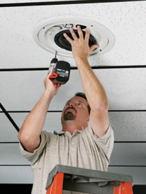 man installing ceiling speaker