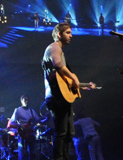 Man playing acoustic guitar on stage