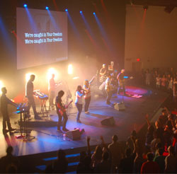 House of worship sound tech with his hands on a Yamaha digital audio mixing console