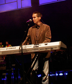 Male keyboard player at a keyboard on stage