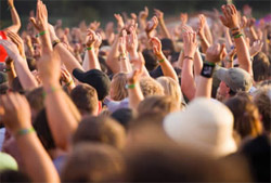 Music Lovers standing outdoors with their hands raised